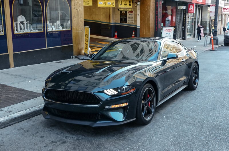 Front profile of green Mustang Bullitt parked on the side of the street