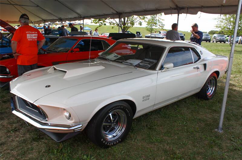 Front profile of white Mustang Boss parked under tent