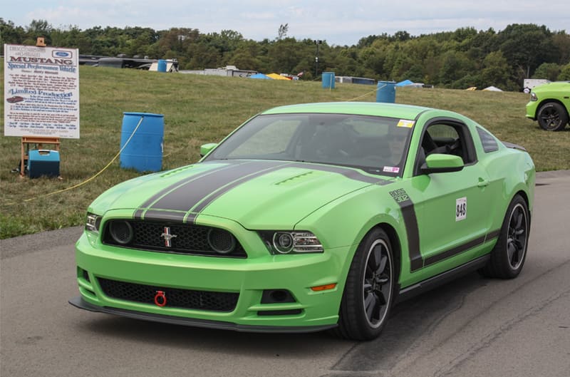 Front of green Mustang Boss driving on road