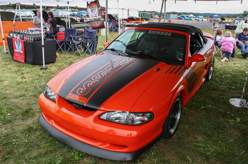 Front of red Mustang Boss Shinoda parked under tent