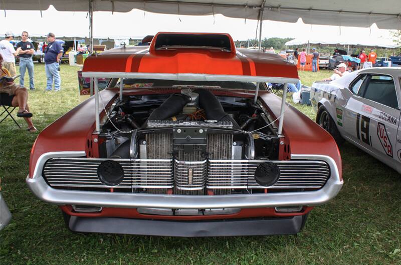 Front of red Mustang Boss with hood lifted