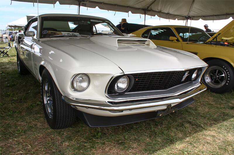 Front of white Mustang Boss parked under tent