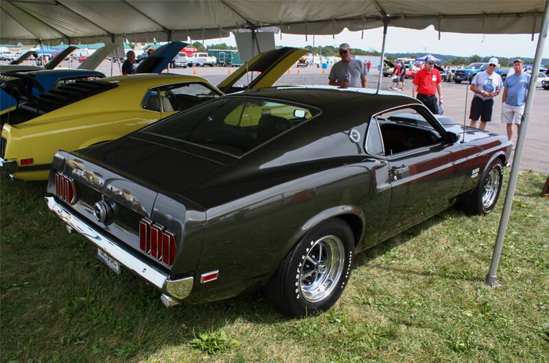 Rear of black Mustang Boss parked under tent