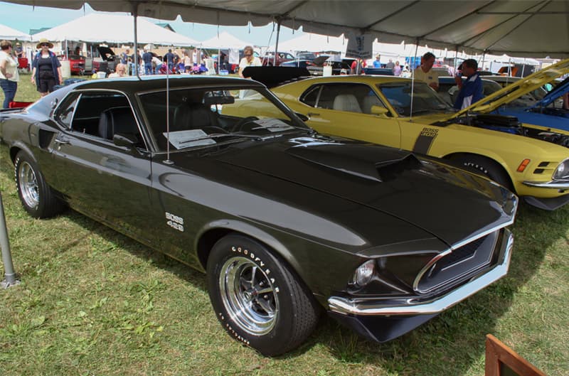 Front profile of black Mustang Boss parked under tent