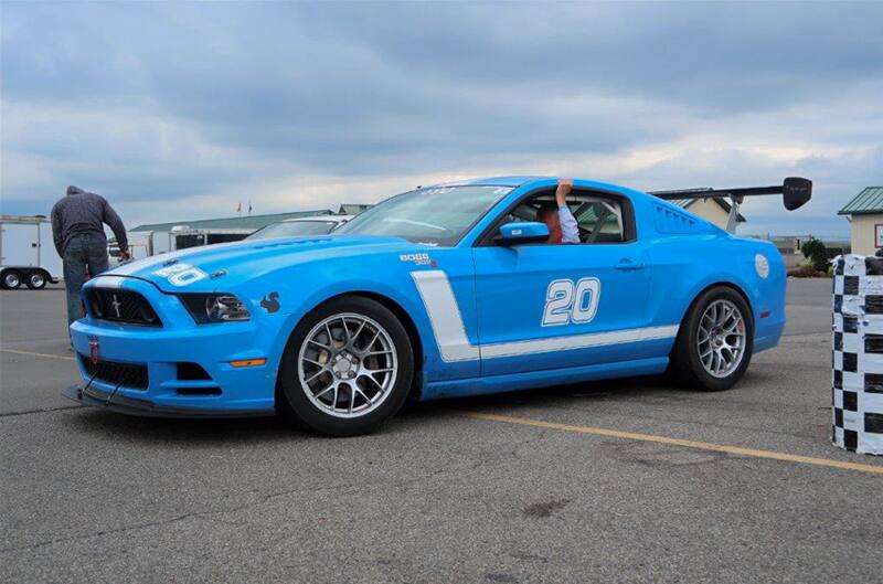 Profile of blue Mustang Boss in parking lot