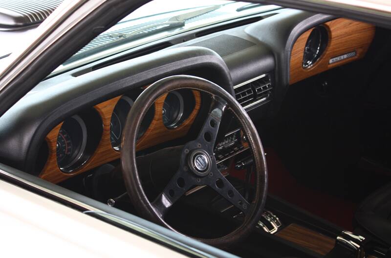 Interior shot from driver side of steering wheel and dashboard