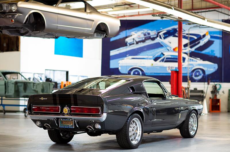 Rear profile of a black Shelby Super Snake in a garage hall