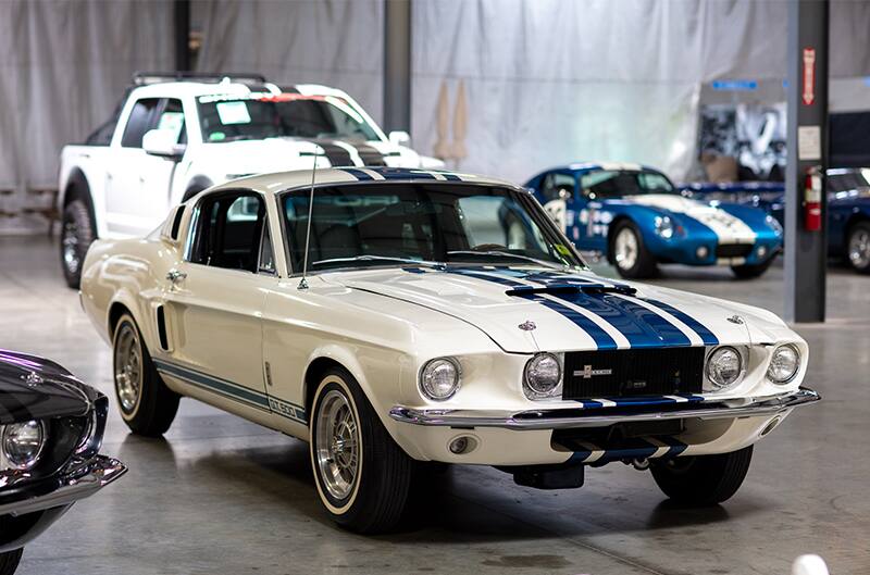 Front of white Shelby Mustang GT 500 in garage hall