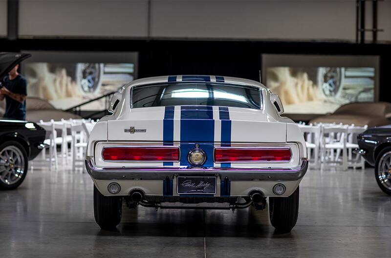 Rear of white Shelby Mustang GT 500 in garage hall