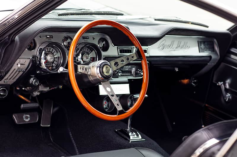 Interior close up of front seat steering wheel from driver side