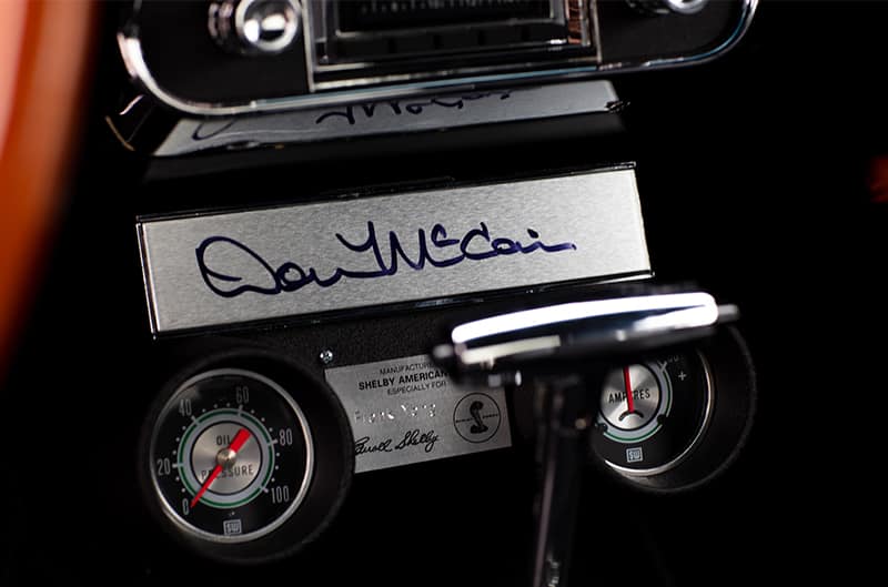 Close up of signature under radio on the dashboard