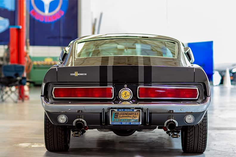Rear of black Shelby Mustang GT in garage hall