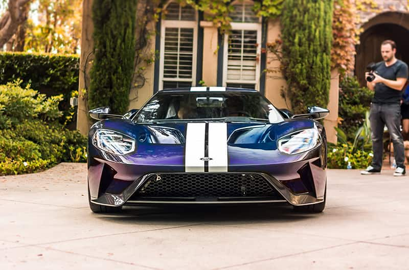 Front of the Mystichrome GT parked in the driveway with a man recording it