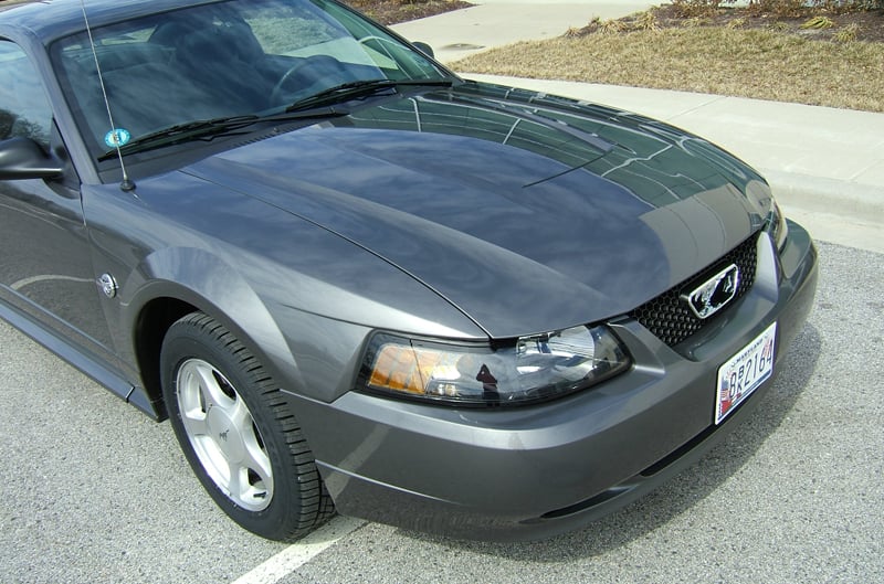 Close up front side of dark gray Mustang in parking lot