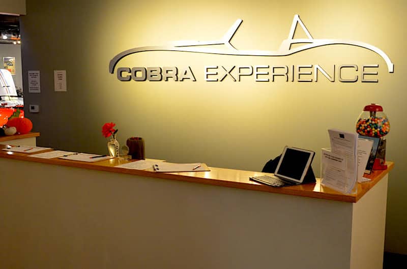 Close up of front desk with Cobra Experience visual on wall
