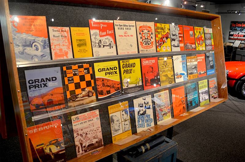 Bookshelf of various Grand Prix magazine covers on display