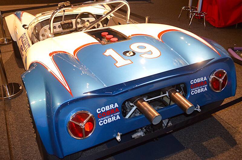 Rear of a white and blue Shelby Cobra on display in museum