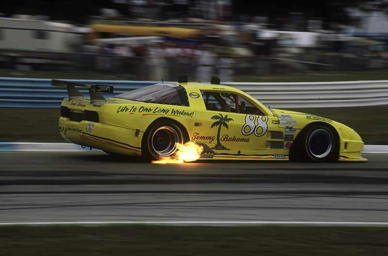 Profile of a yellow Tommy Bahama Goose Racer driving on the track