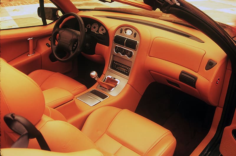 Interior close up from driver side of all orange front seat