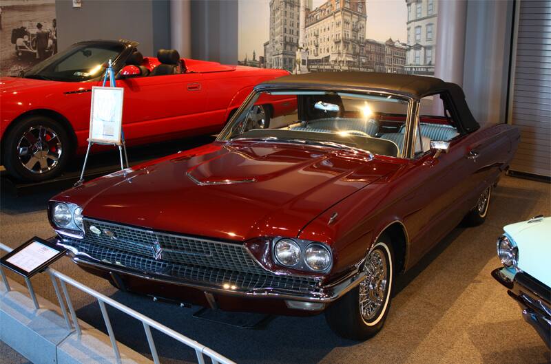 Front of red Thunderbird droptop with black roof on display