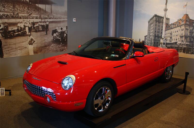 Front profile of red Thunderbird droptop with roof down on display