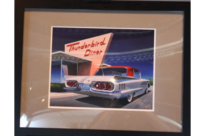 Picture of the rear of a white Thunderbird with red roof in front of the Thunderbird Diner