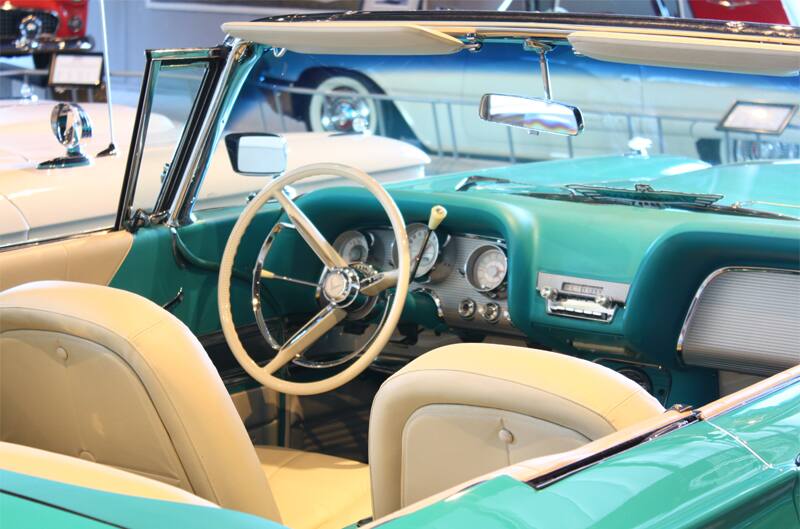 Interior close up from behind passenger side of front seat of teal Thunderbird droptop