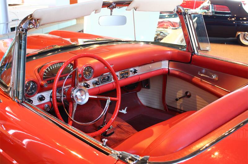 Interior close up from driver side front seat of red Thunderbird with roof down