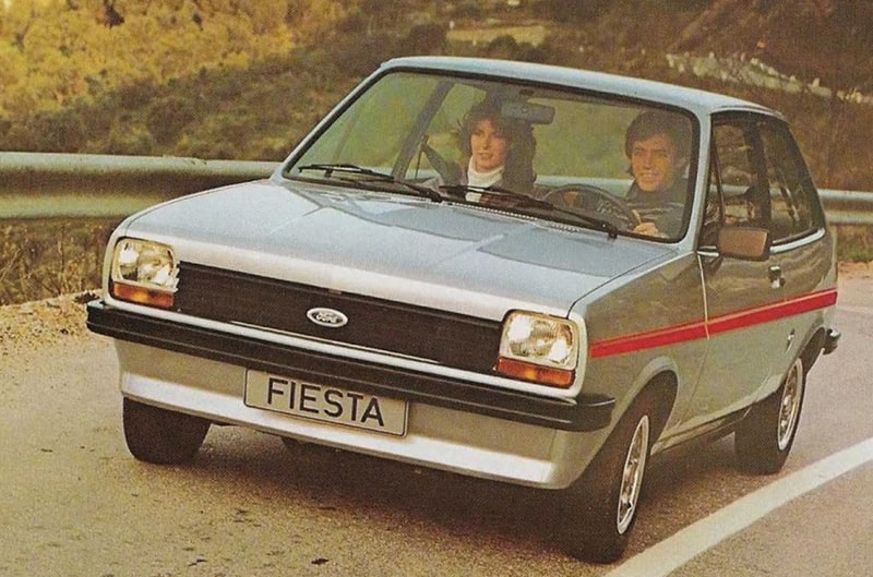 Front of vintage silver Fiesta with man and woman driving