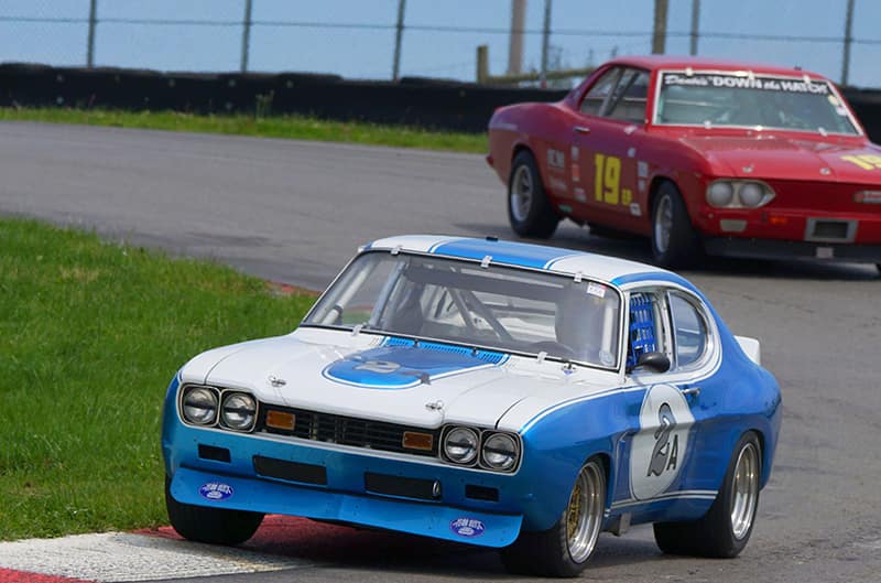 Front of blue Capri leading on the track