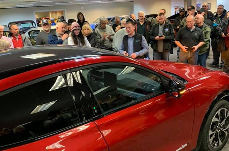 Crowd of people with Mustang Mach E