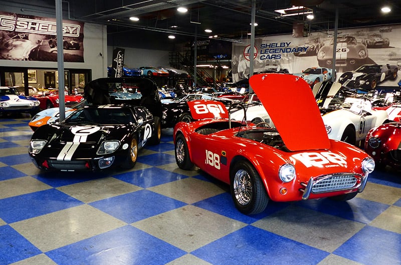 Black GT40 and Red shelby cobra in hillbank showroom