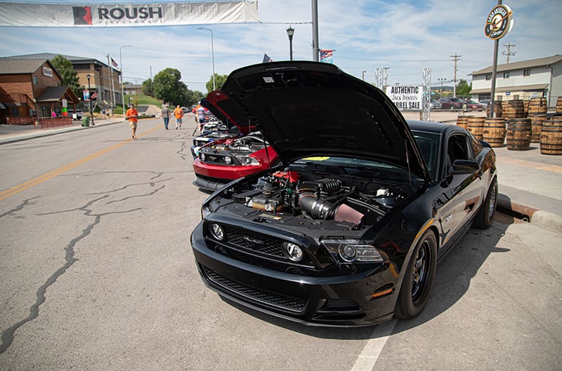 Black supercharged S197 Mustang with hood open