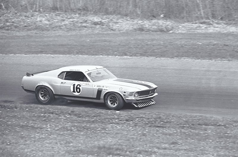 Black and white photo of boss 302 on track