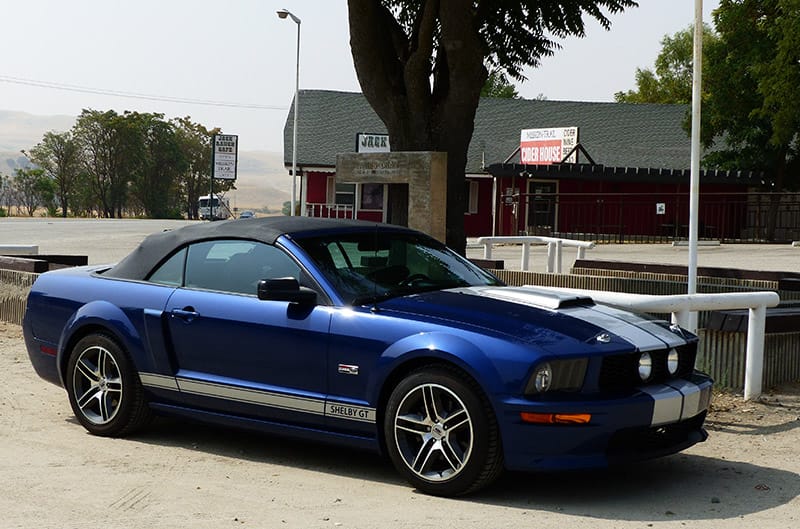 Blue Shelby Mustang in front of James Dean memorial
