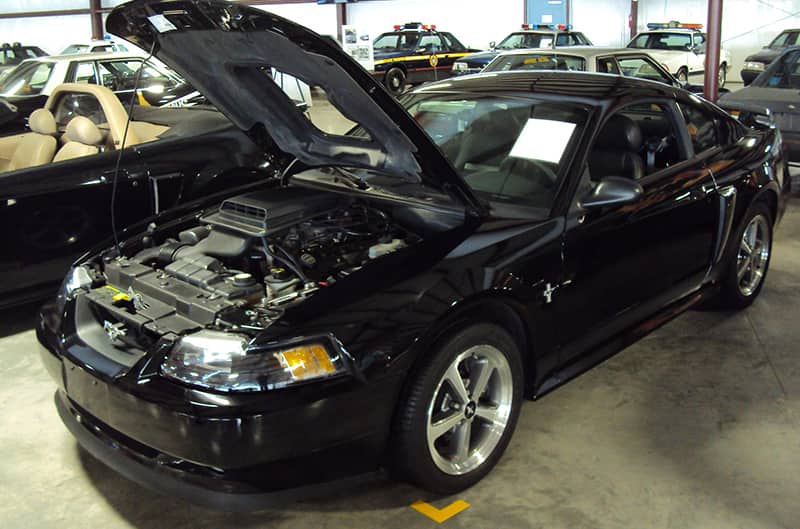 Black 2003 Mach 1 Mustang with hood up