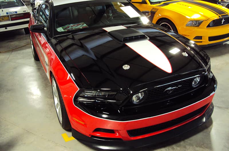 Black and Orange S197 Mustang in museum