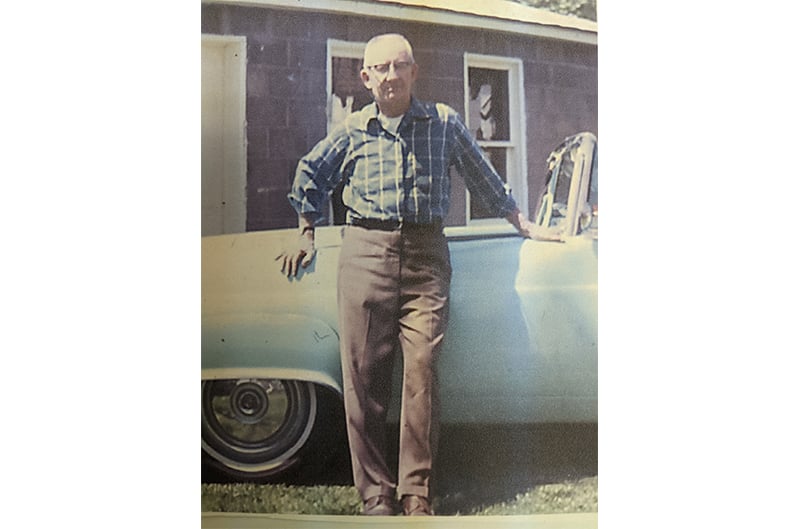 Man standing with 1955 Ford