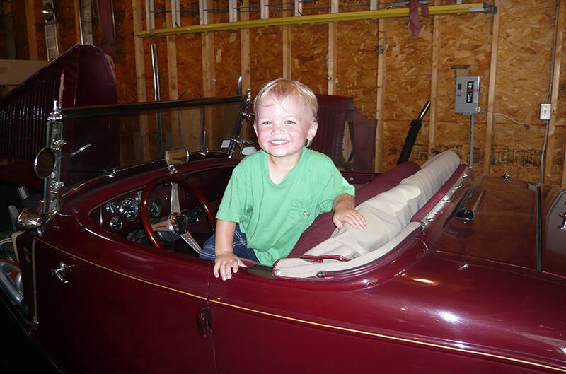 Young child standing in roadster