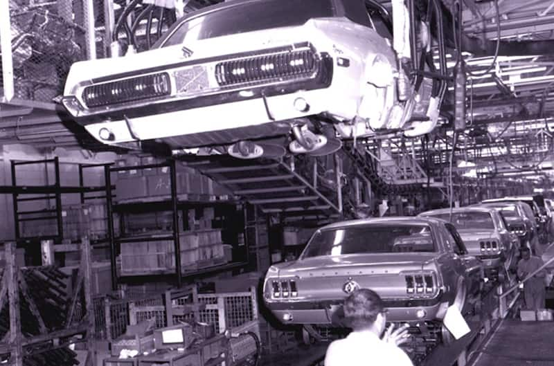 Black and white photo of mustangs on the assembly line