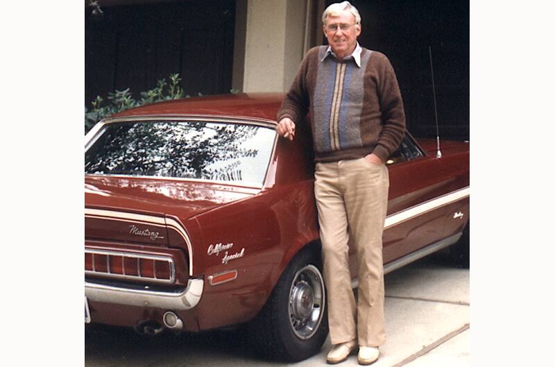 Older man standing with 1960's California Special mustang in red