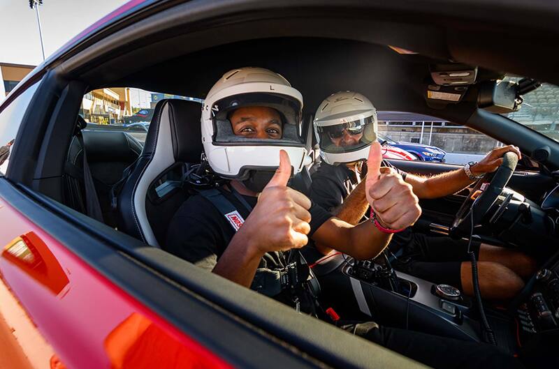 Passenger and driver in GT500 with thumbs up