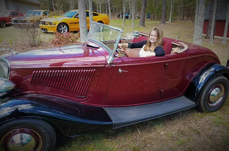 1934 Ford with Leah sitting in the drivers seat