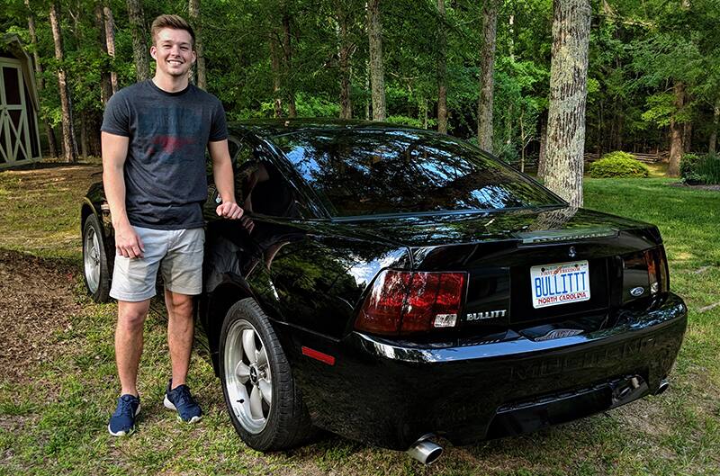 Brandon Standing behind his Bullitt Mustang