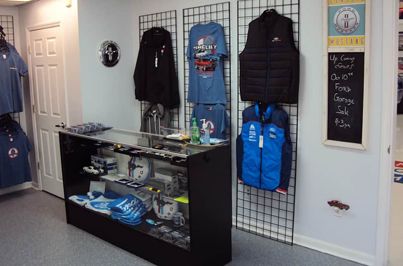 Display case and clothing racks with mustang gear for sale