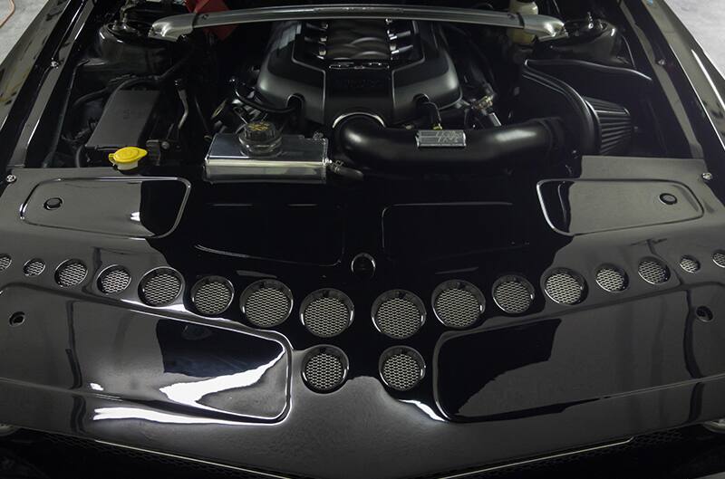 Engine bay and core support area of Black mustang