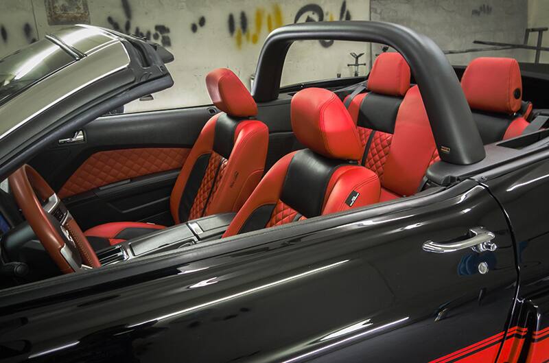 Interior view from outside of driver side. Red and black leather interior