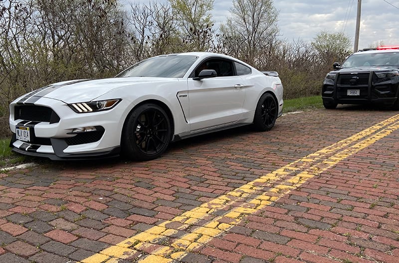 White GT350 with Police officer behind them