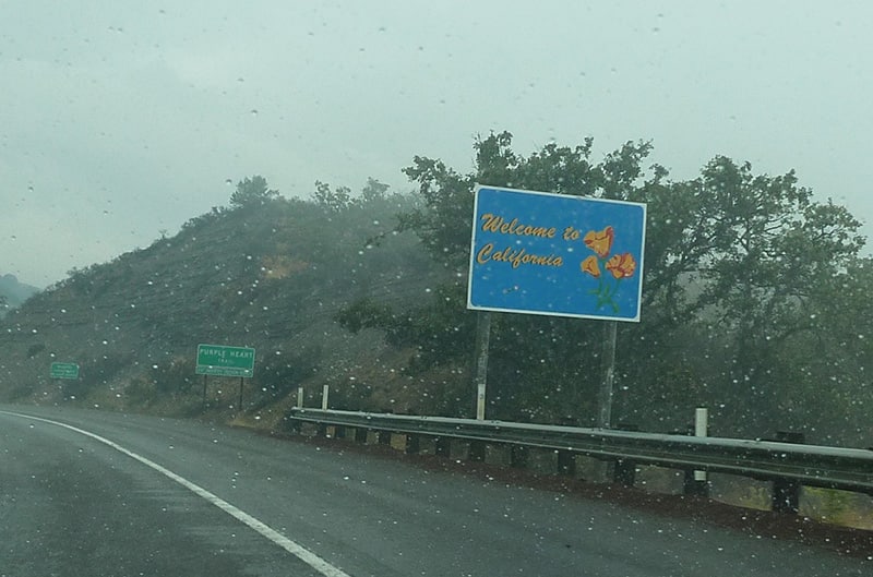state sign on freeway during rain