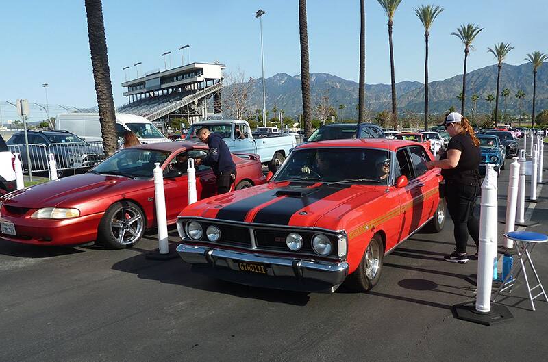 Ford Torino in orange pulling into show